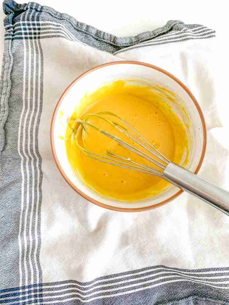 whisking sauce ingredients together