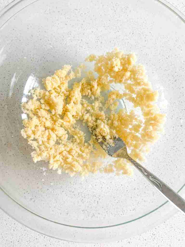 butter and sugar getting mixed with a fork