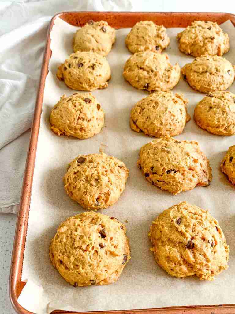 freshly baked mini sourdough chocolate chip pumpkin cookies on a sheet pan