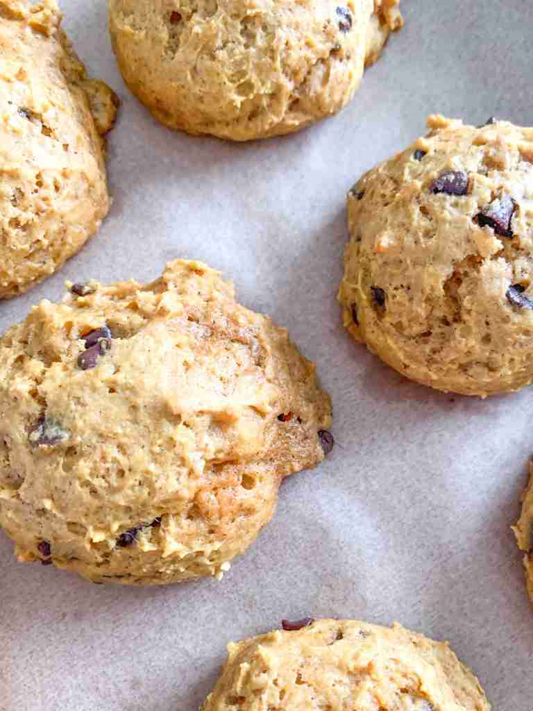 freshly baked mini sourdough chocolate chip pumpkin cookies on a sheet pan