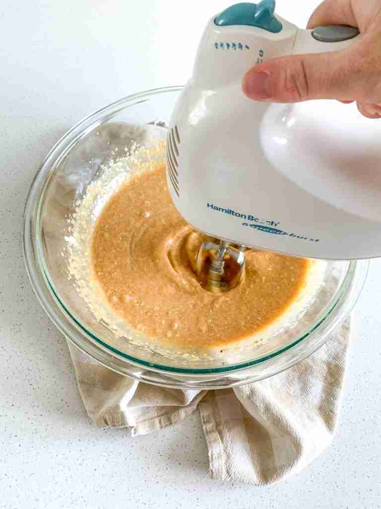 mixing pumpkin cake batter
