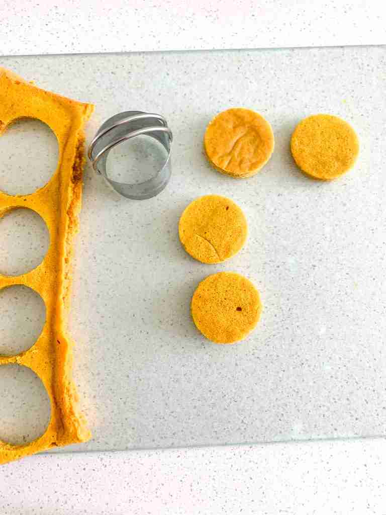cutting out circles of pumpkin cake