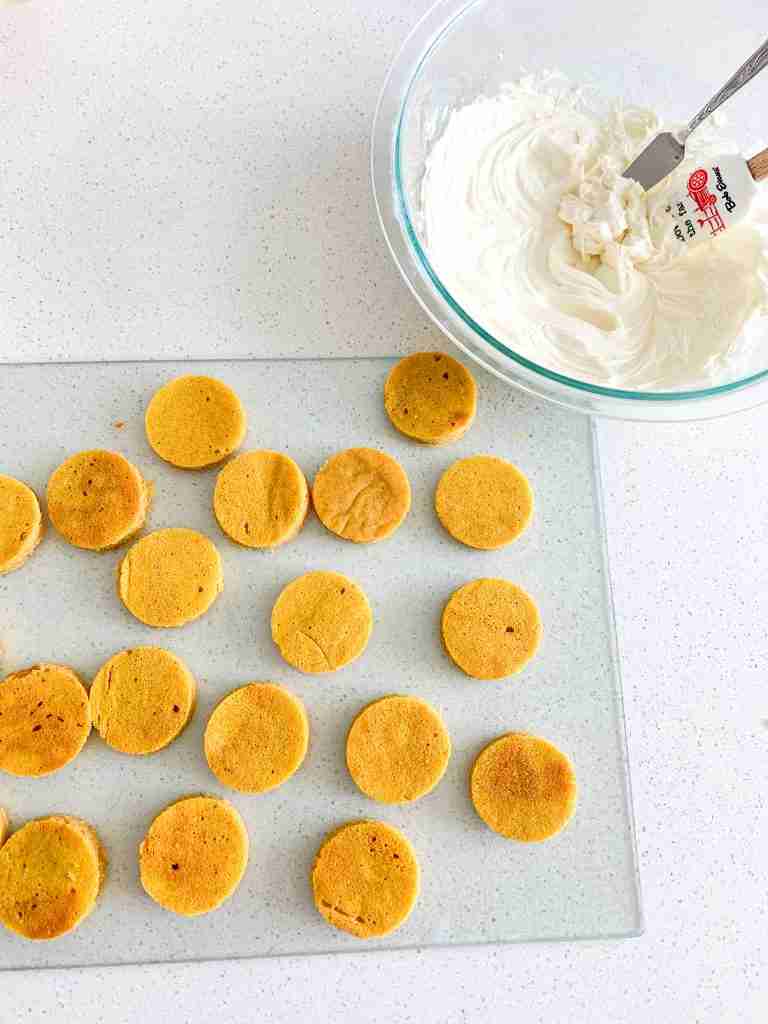 pumpkin cake cut out and cream cheese frosting ready to assemble