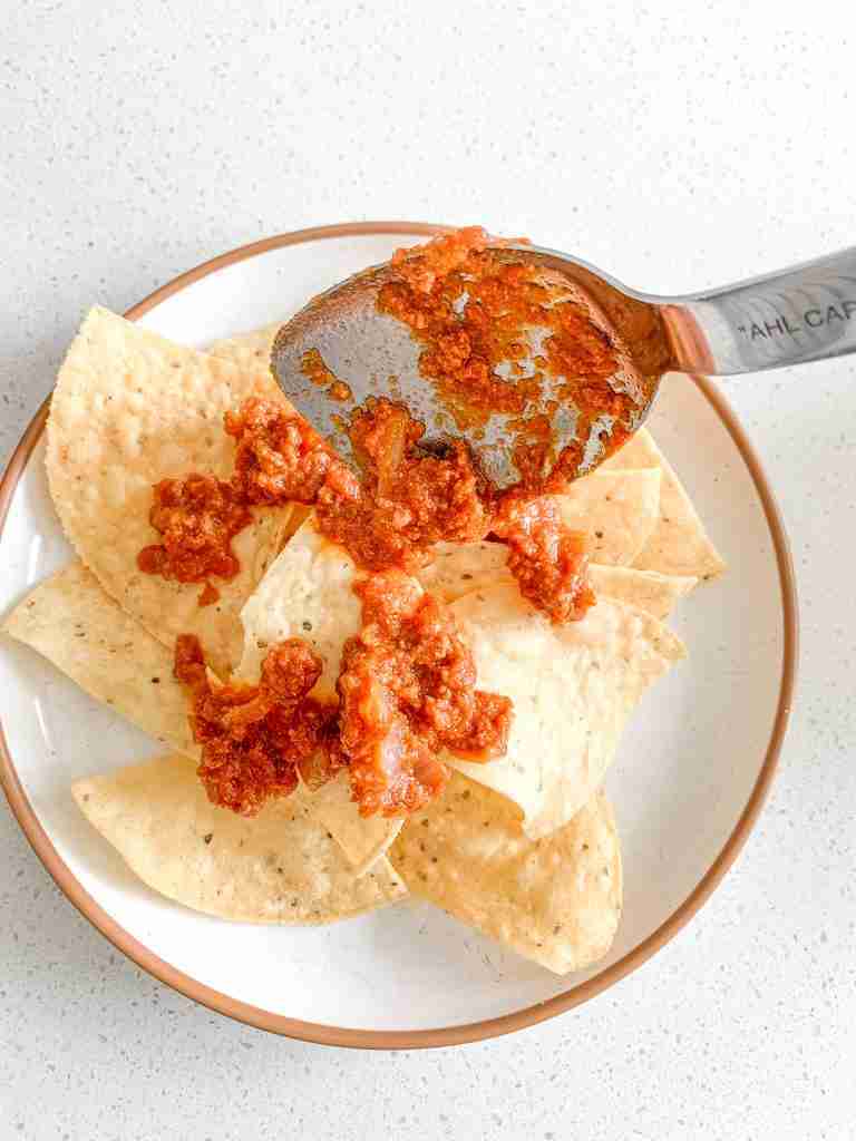 adding walking taco meat to tortilla chips