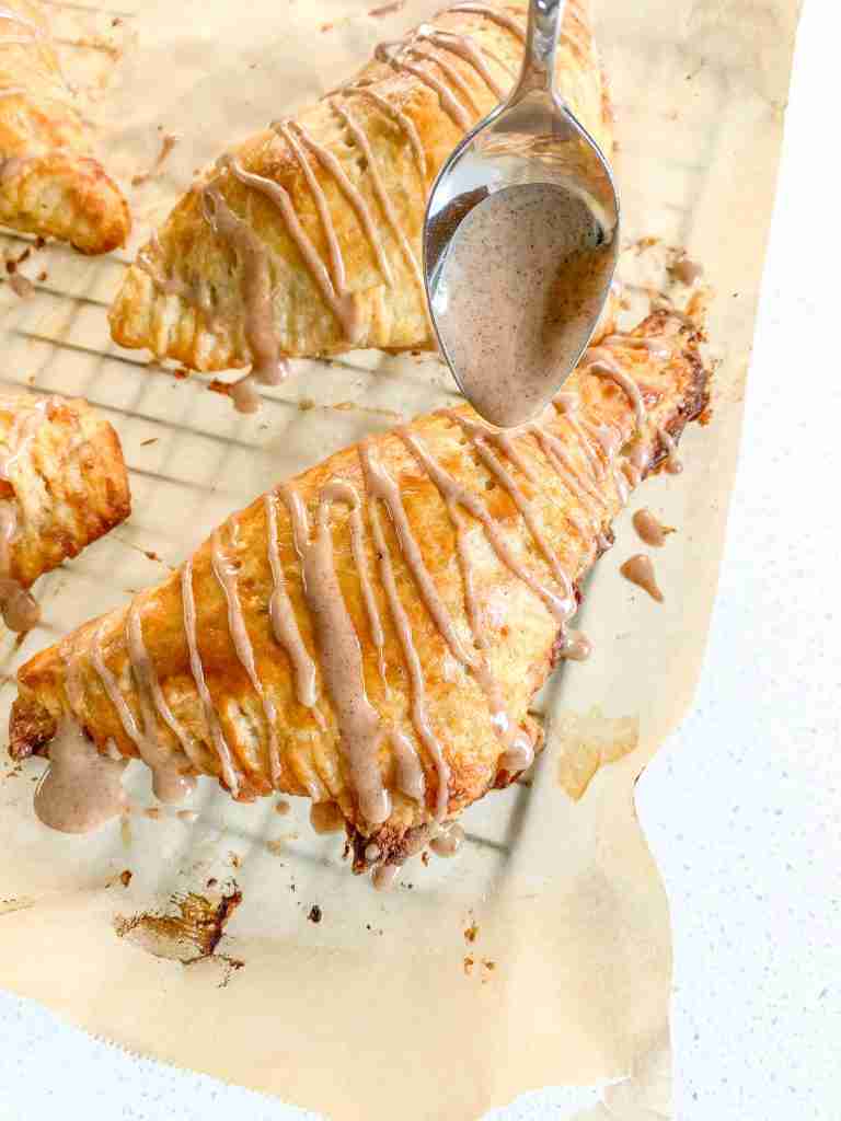 drizzling baked apple turnovers with frosting