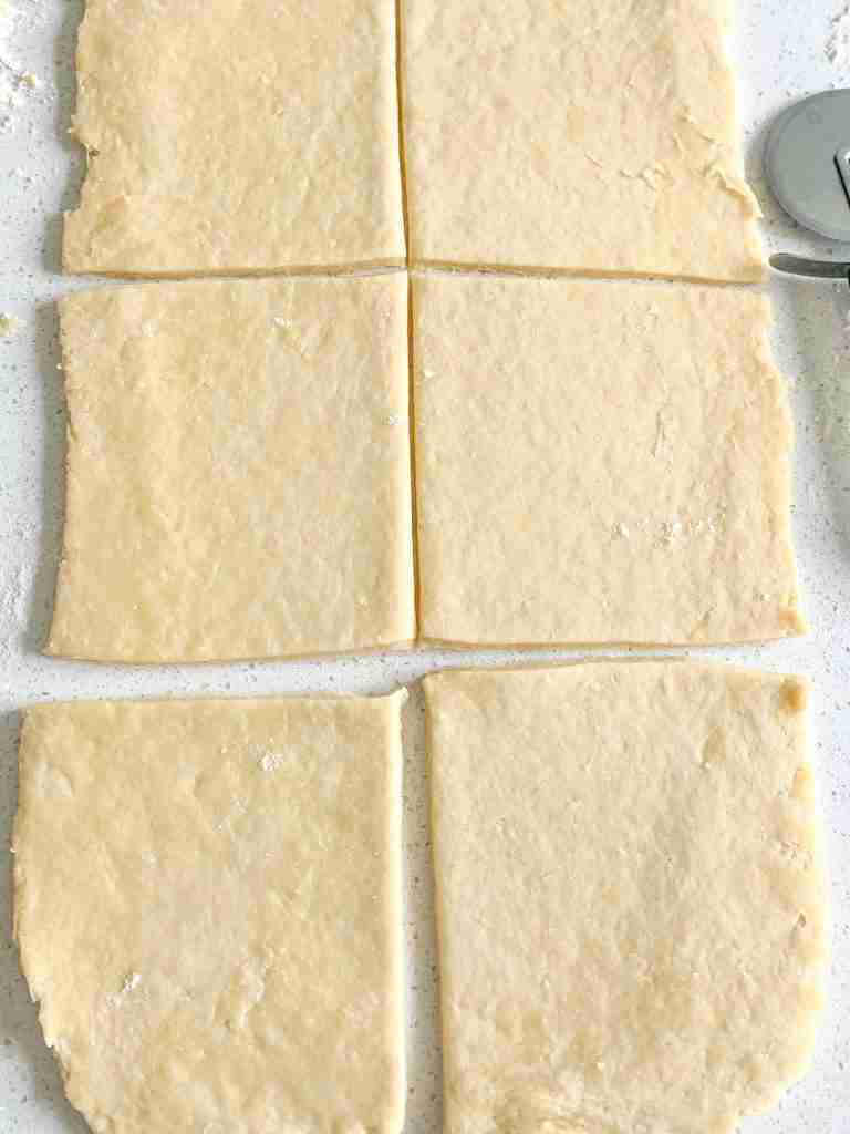 slicing turnover puff pastry dough into 6 sections
