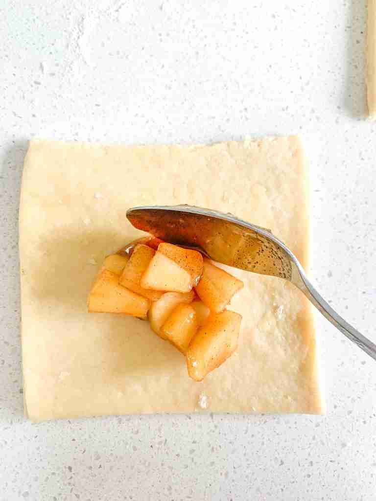 adding apple filling to sourdough puff pastry dough