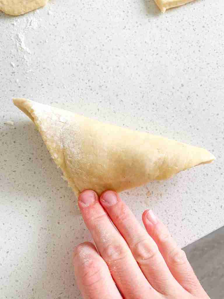 folding sourdough turnover dough in half over the filling