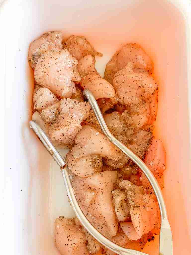 seasoning chicken with salt and pepper