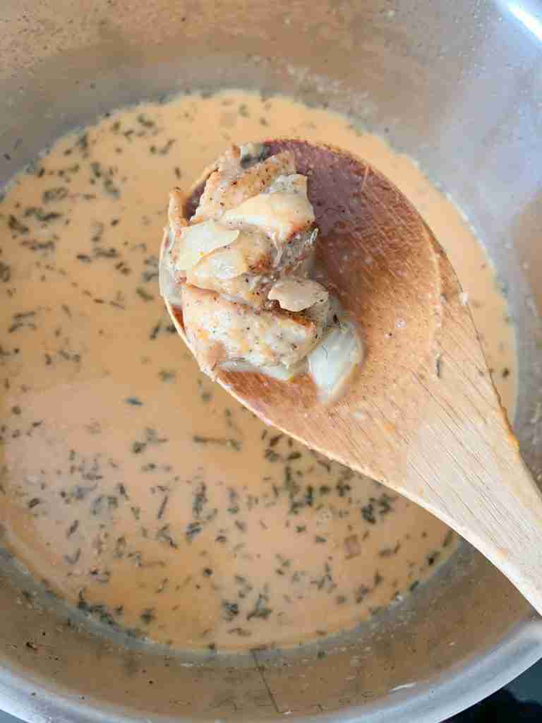 adding cooked chicken into soup