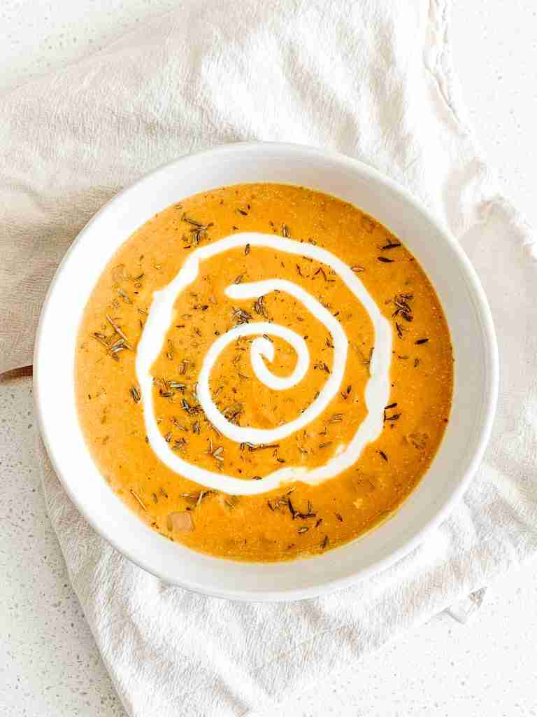 freshly made pumpkin chicken soup with a cream swirl
