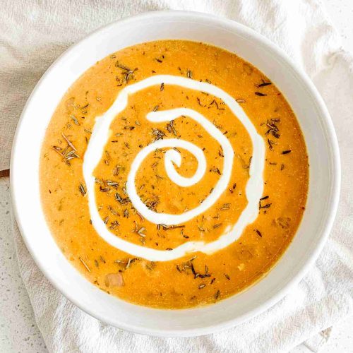 freshly made pumpkin chicken soup with a cream swirl