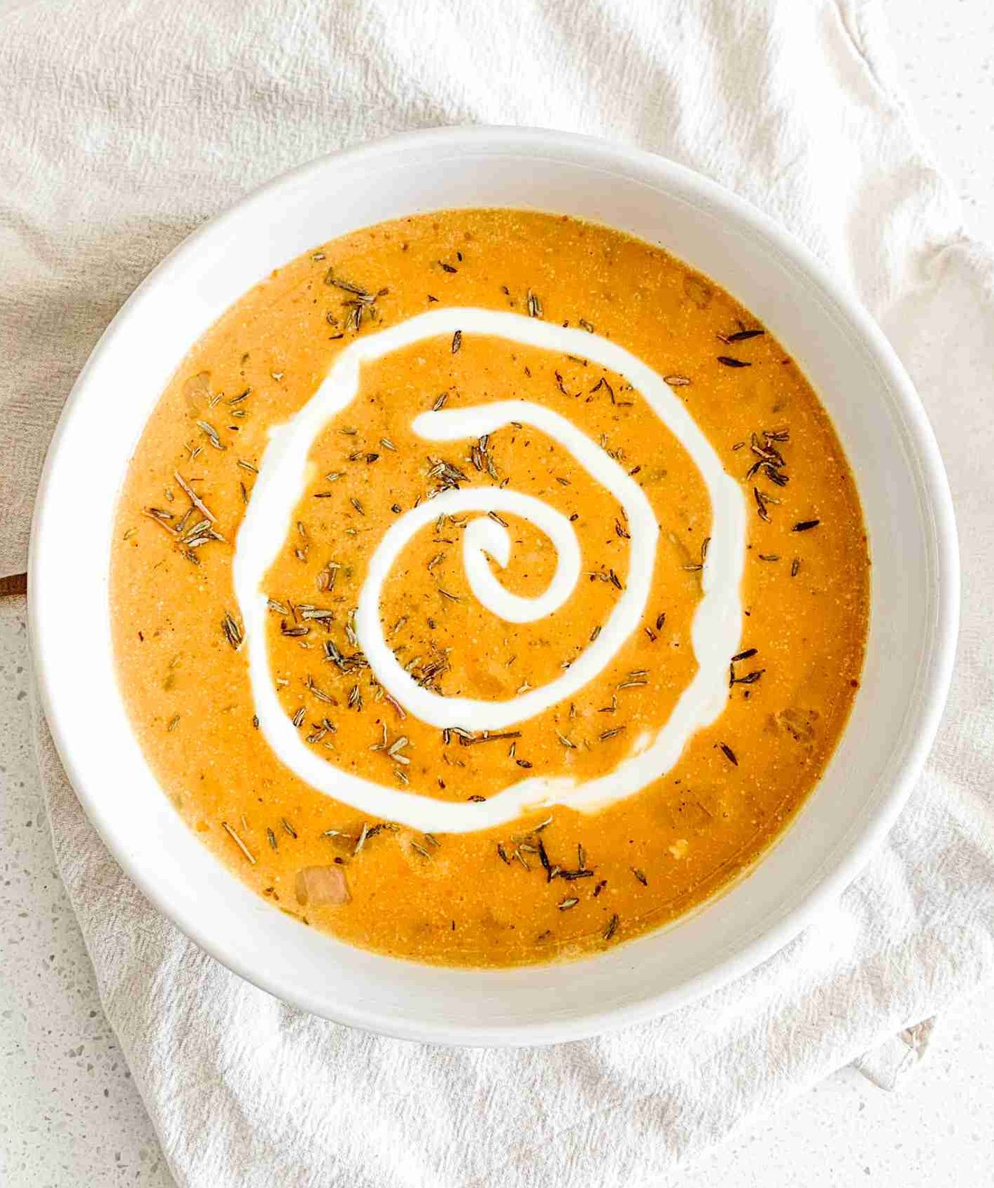 freshly made pumpkin chicken soup with a cream swirl