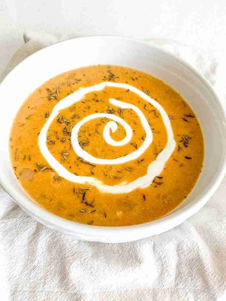 freshly made pumpkin chicken soup with a cream swirl