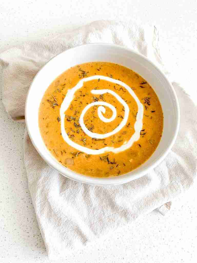 freshly made pumpkin chicken soup with a cream swirl