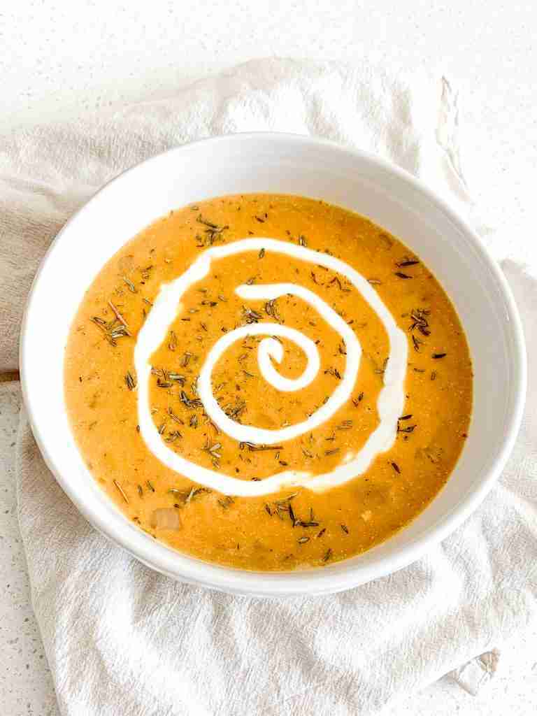 freshly made pumpkin chicken soup with a cream swirl