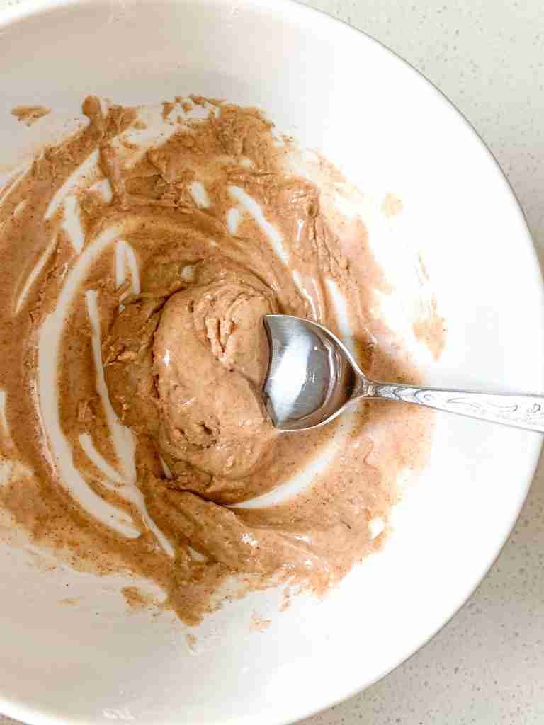 mixing together cinnamon frosting drizzle for turnovers