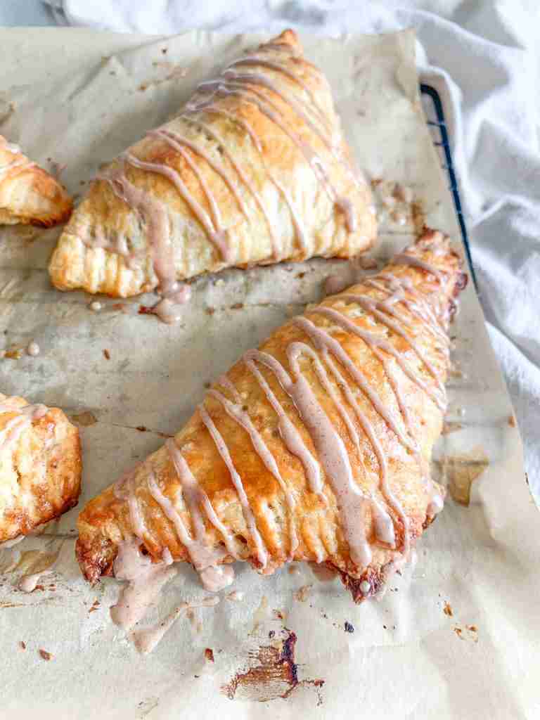 freshly baked sourdough apple turnovers with cinnamon frosting drizzle