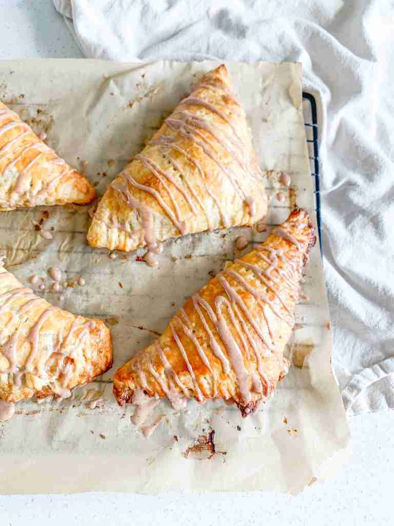 freshly baked sourdough apple turnovers with cinnamon frosting drizzle