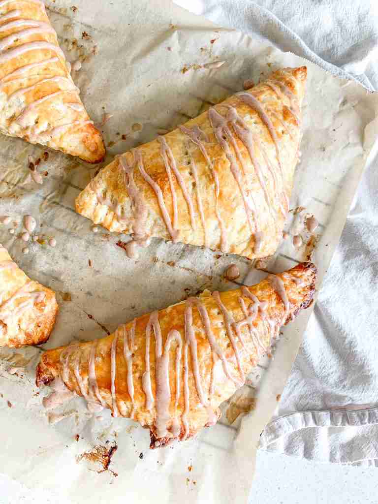 freshly baked sourdough apple turnovers with cinnamon frosting drizzle