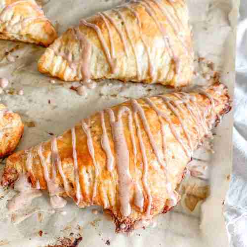freshly baked sourdough apple turnovers with cinnamon frosting drizzle
