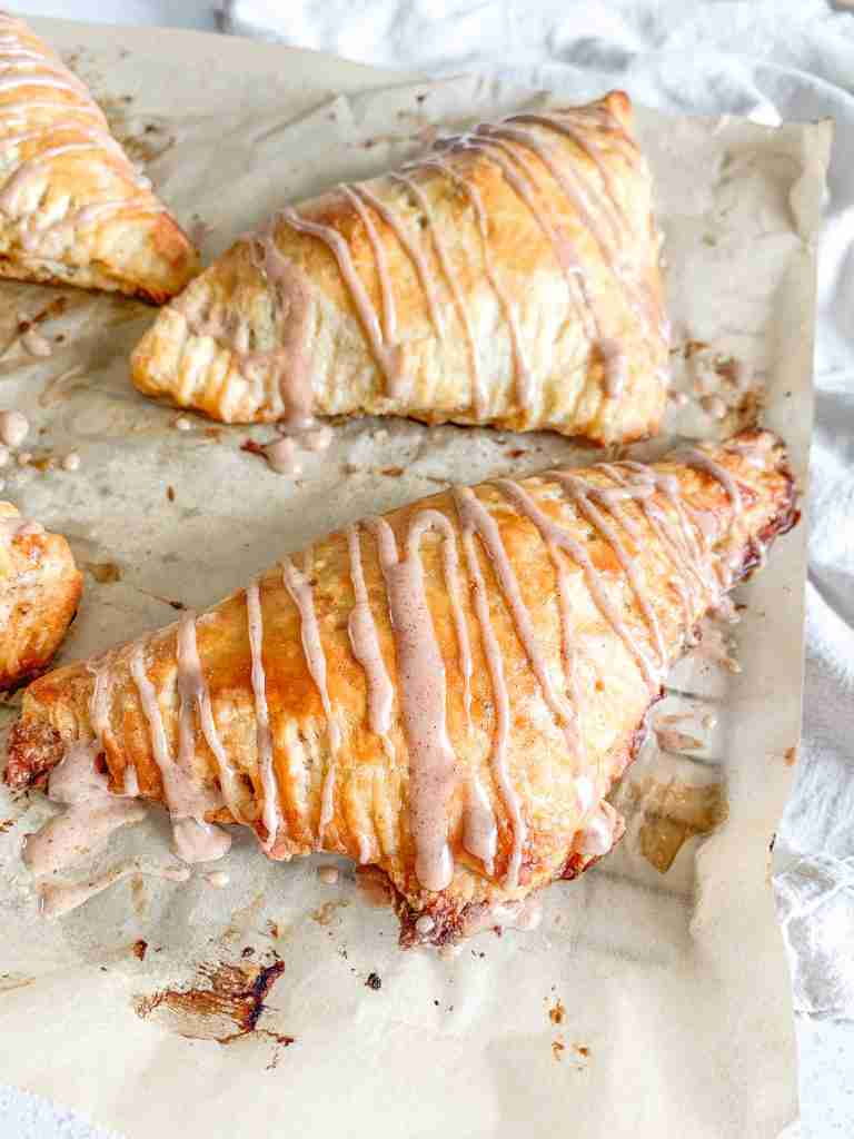freshly baked sourdough apple turnovers with cinnamon frosting drizzle