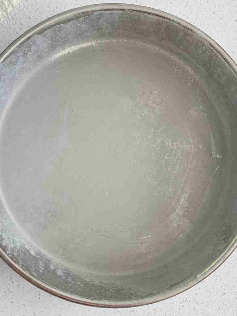 cake pan buttered and floured so it's prepared for biscuits