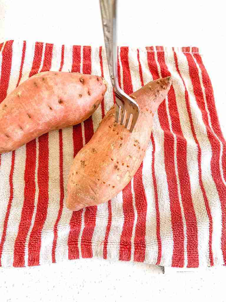 poking sweet potatoes with fork before baking