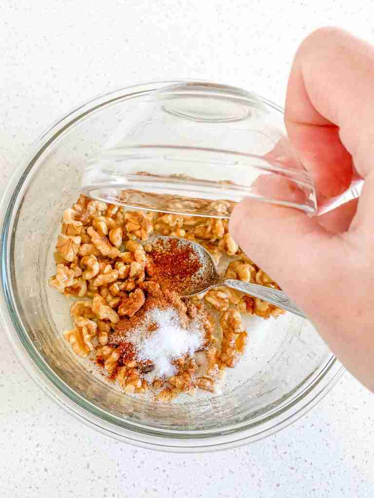 adding seasonings to walnut topping mix