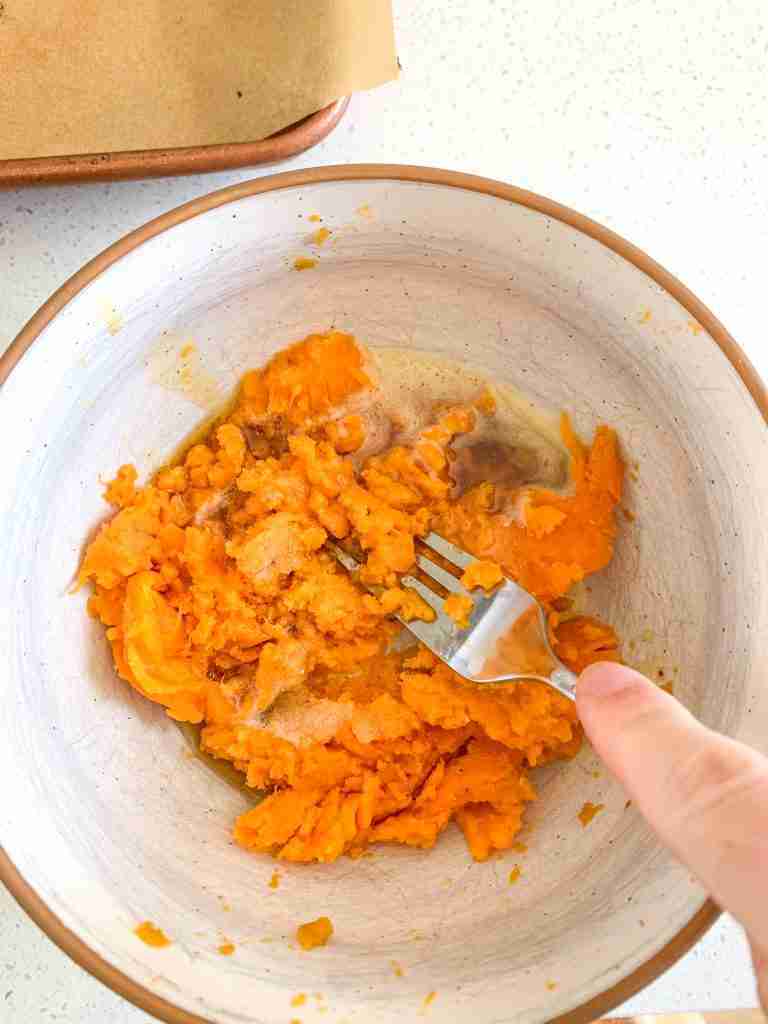 mashing baked sweet potatoes