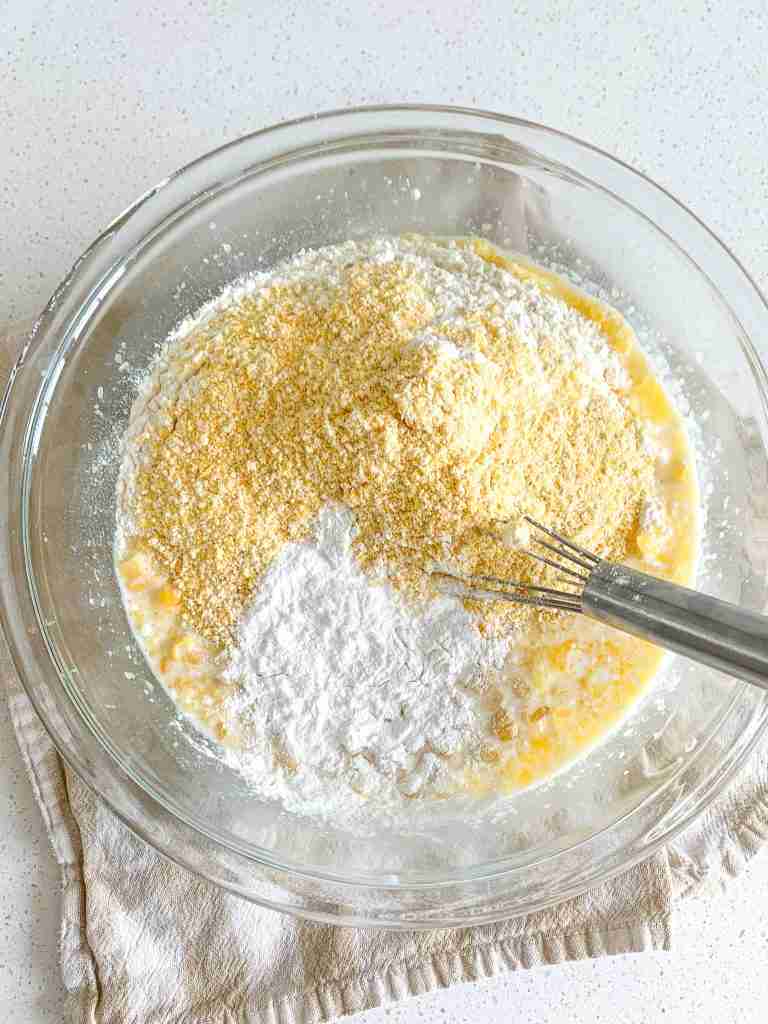 mixing in dry ingredients to corn casserole batter