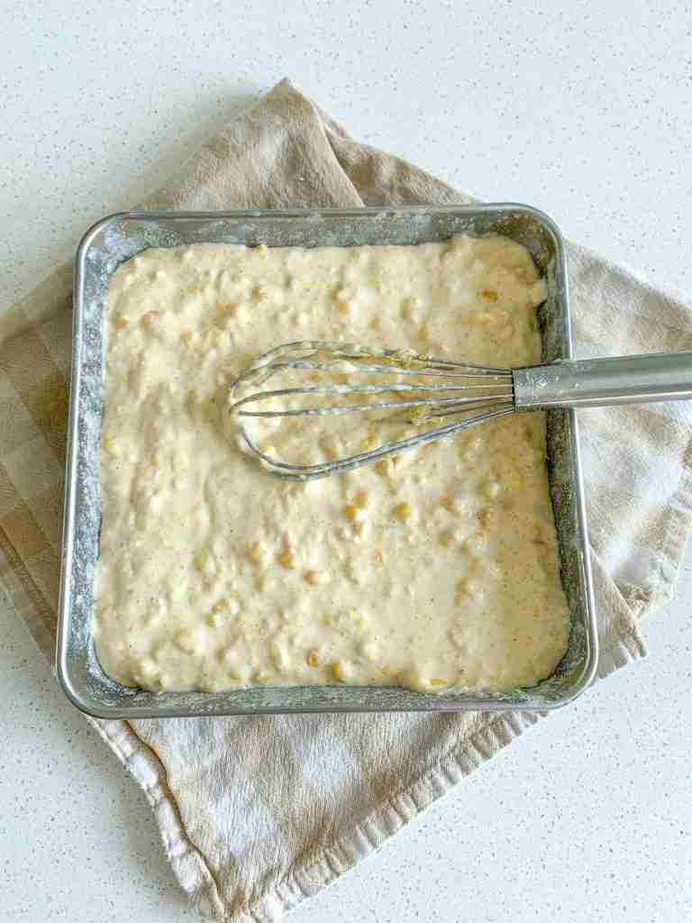corn casserole batter smoothed out in baking pan