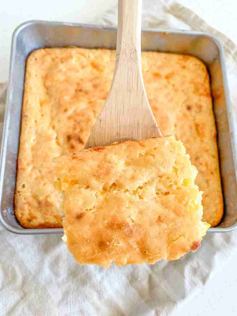 spoonful of freshly baked sourdough cheesy corn casserole