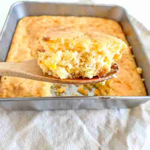 spoonful of freshly baked sourdough cheesy corn casserole