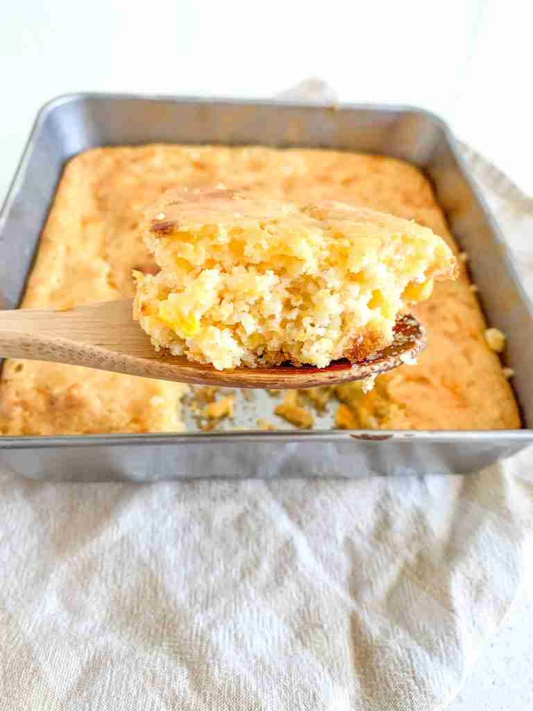 spoonful of freshly baked sourdough cheesy corn casserole