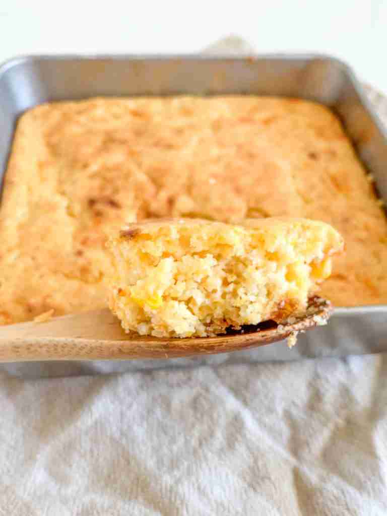 spoonful of freshly baked sourdough cheesy corn casserole