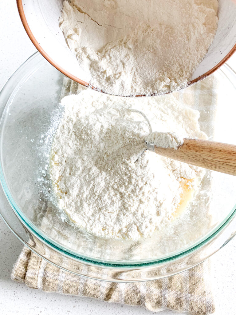 adding flour to hawaiian roll dough mix