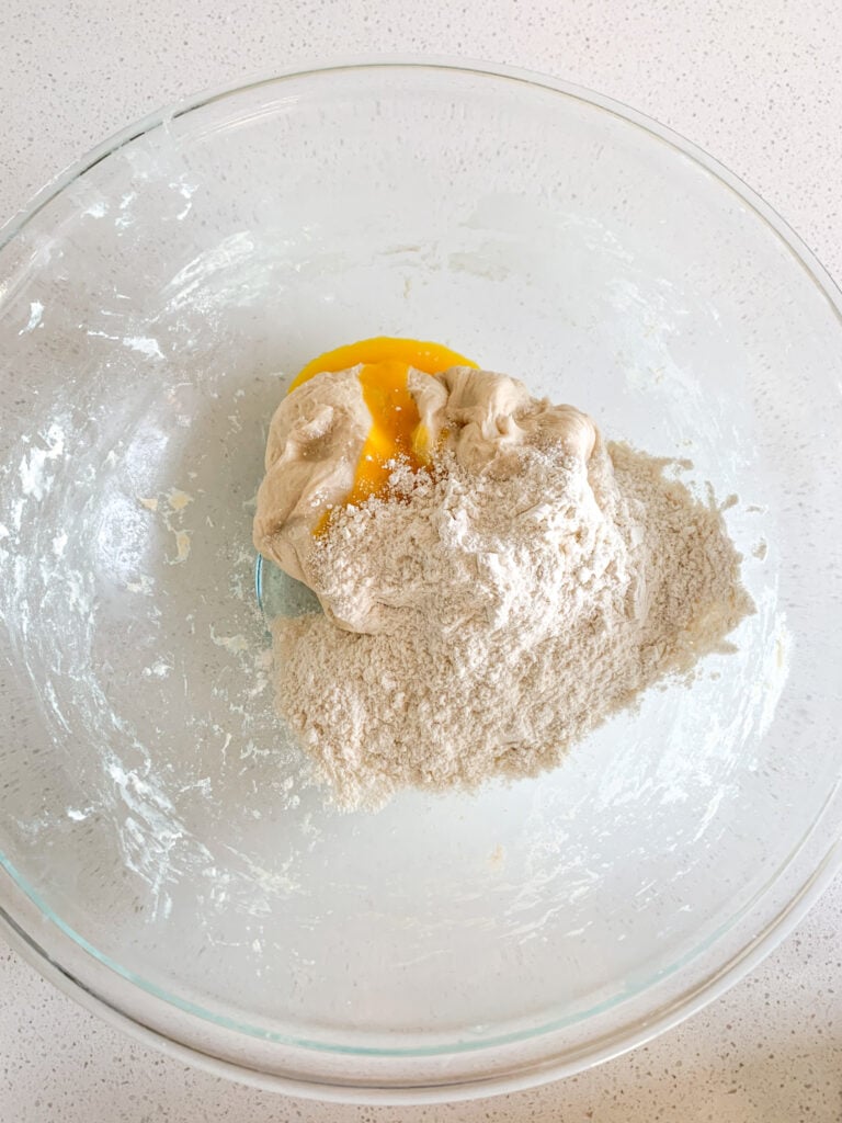 adding egg and flour into fermented danish dough