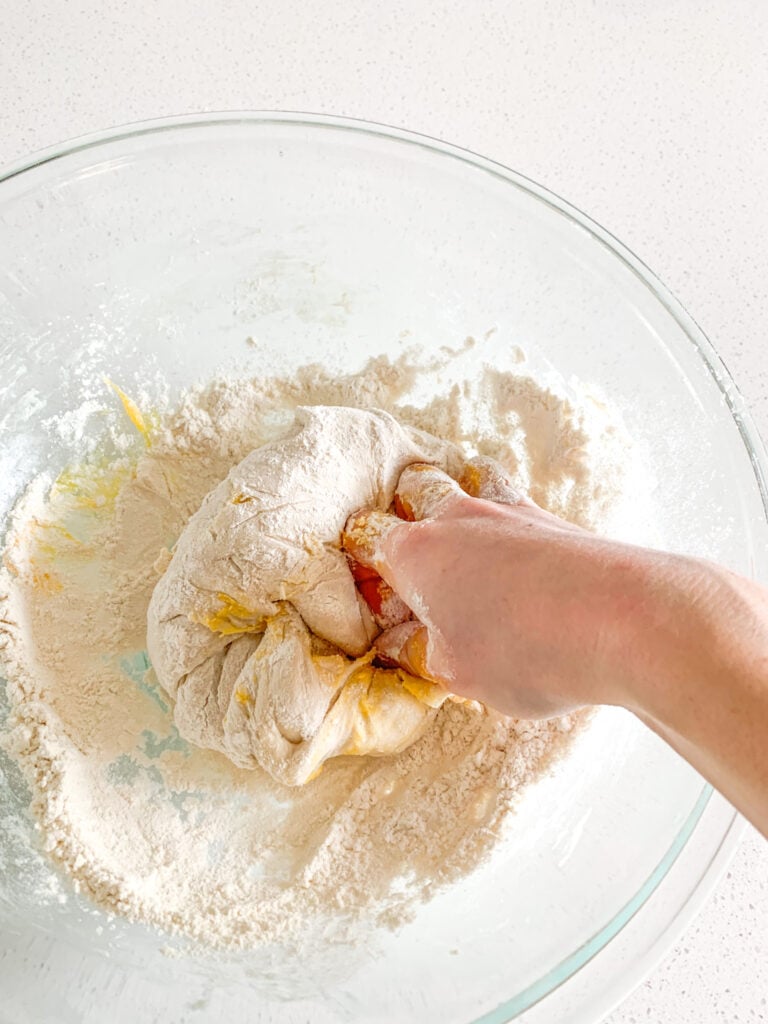 mixing egg and flour into fermented danish dough