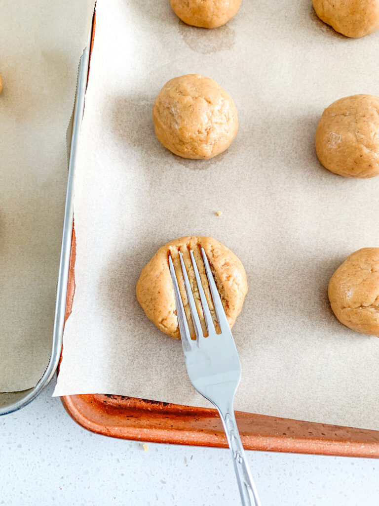 flattening peanut butter cookies with fork