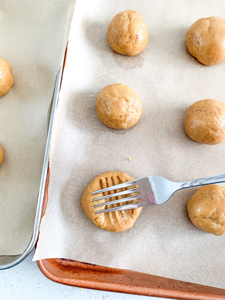 flattening peanut butter cookies with fork
