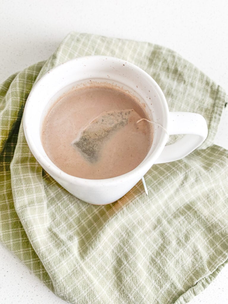 hot chocolate steeping with a bag of peppermint tea