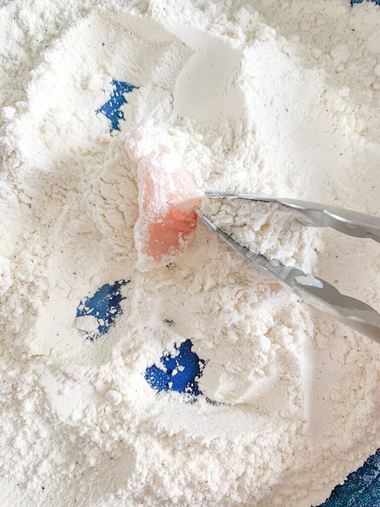 coating chicken in flour for dredging
