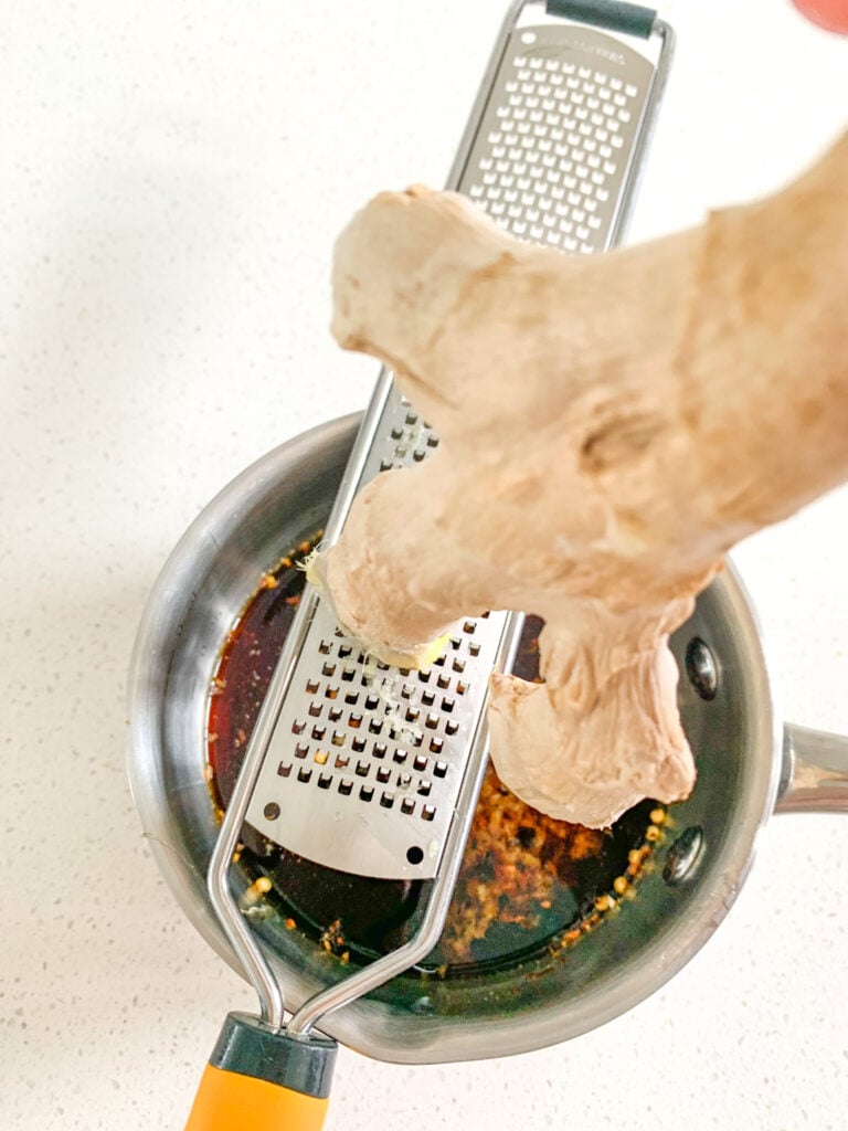 grating fresh ginger for sauce