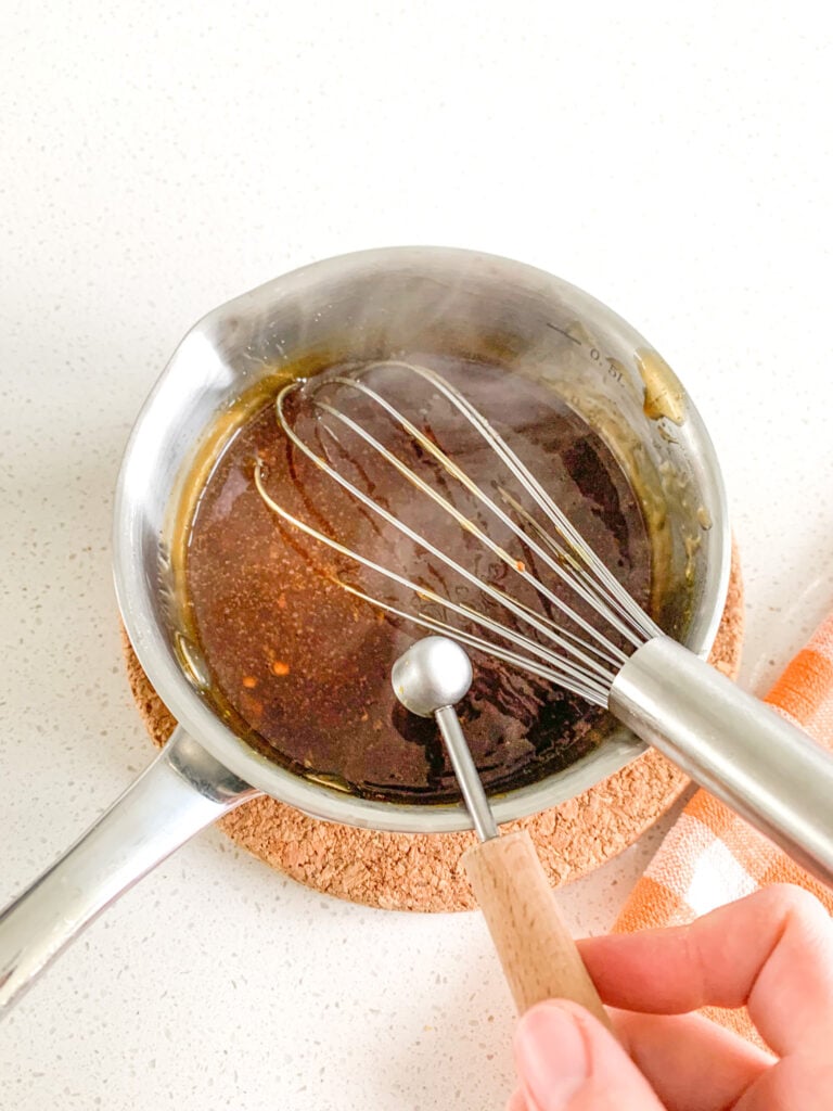 whisking orange zest into sauce