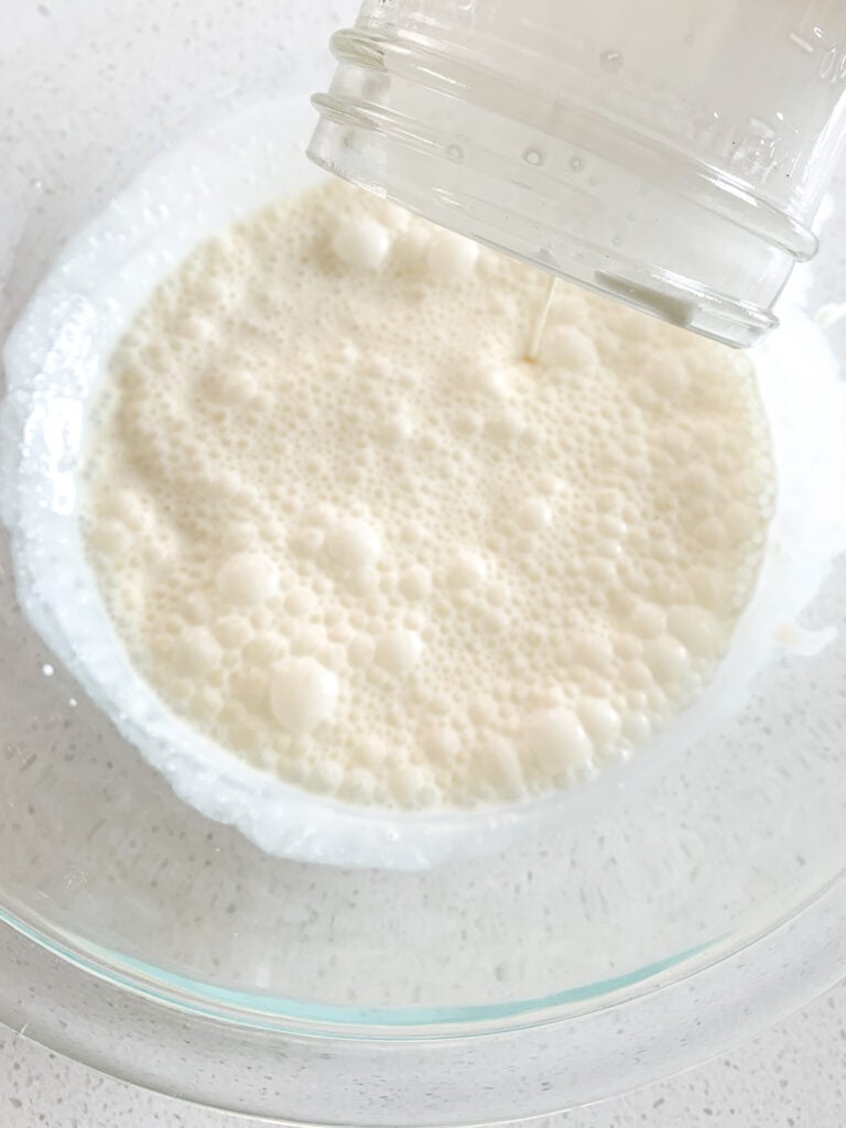 pouring ingredients for whipped cream into a bowl