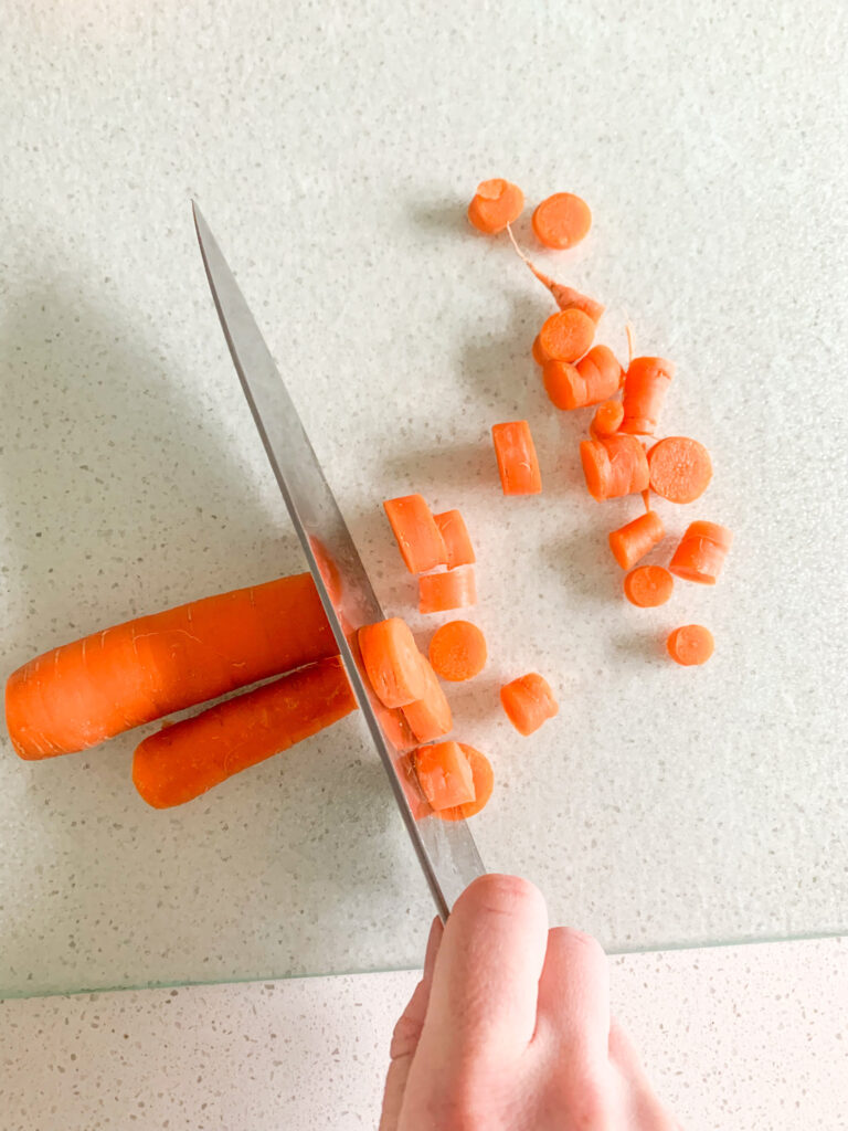 chopping carrots for stock