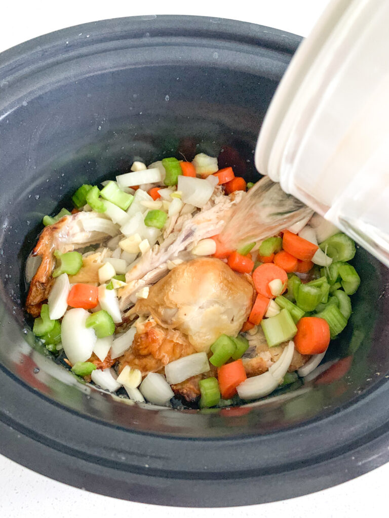pouring water into slow cooker
