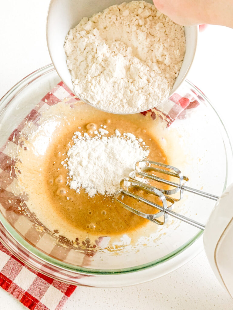 adding flour to sourdough cookie dough