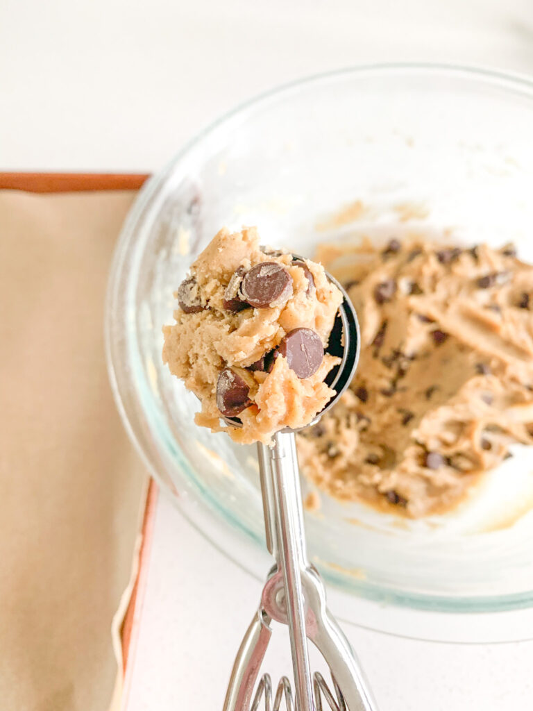 scooping brown butter sourdough cookie dough